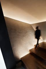 Walnut stairs are side-lit by LEDs.