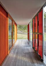 Both sets of panels slide open for maximum views and solar gain; in inclement weather, they shutter completely, while clerestory windows bathe the space in light.  Photo 8 of 10 in An Off-the-Grid Prefab that Combines Open Plan Living With Rugged Durability