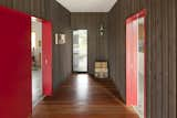 Hallway and Medium Hardwood Floor Mahogany flooring, a continuation of the mahogany backyard deck and front porch, is enhanced with a clear finish. Vintage suitcases sit near rough sawn cedar walls, which are finished with an ebony stain.  Search “passivhaus institut announces 2014 finalists” from A Green Portland Home Built to Passive House Standards