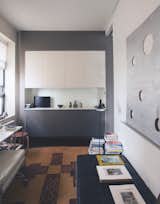 In the study of American conceptual artist Glenn Ligon, a 1966 cardboard work by Cady Noland hangs on the right-hand wall, above a collection of books and framed pieces. (We also spy a Stool 60 by Aalto at the far left.)  Photo 3 of 8 in Inside the Homes of 7 Creatives by Aileen Kwun