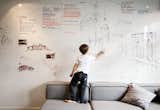 Living Room and Sofa An entire wall is covered with a dry-erase surface from Formica, where Parzyszek and his son Bartek can sketch.  Photo 1 of 12 in This Tiny Warsaw Studio Instantly Changes from Office to Playroom