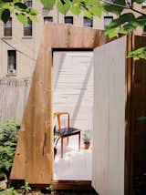 The building’s design was determined by the desire for a strong geometric form and by the materials Hunt could find. The cedar cladding is meant to fade over time.  Search “family builds tiny backyard studio even tinier budget” from An Architect Builds His Own Backyard Oasis From Salvaged Materials