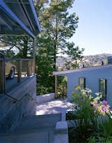 The entire house cantilevers over the slope and features quintessentially midcentury modern features such as a wider private front facade and a butterfly-esque roof.