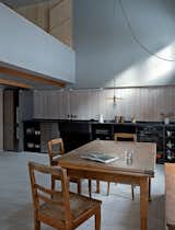 Among the furnishings that came with the house are the table and chairs in the kitchen–dining area. The pendant is by 6a for Izé.  Photo 2 of 12 in A Sliced-Up House Comes Together Again