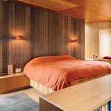 A new home at Sea Ranch, a half-century-old enclave of rugged modernist houses on the Northern California coast, captures the spirit of its surroundings. Boi sconces, which David Weeks designed for Ralph Pucci, illuminate the bedroom. The area rug is by Stephanie Odegard.