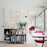 An architect and an interior designer converted this dilapidated toolshed into a modern guesthouse.

In their living room, a print by the abstract expressionist Al Held hangs above a storage unit by Charles and Ray Eames for Herman Miller. The table lamp is by Isamu Noguchi, and the cork floor tiles are from Globus Cork. A Saarinen Executive Arm Chair is at the end of the hall.  Photo 4 of 5 in A Look at Cork Floors in Modern Homes by Zach Edelson