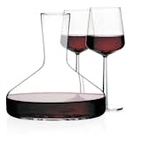 The perfectly formed, mouth-blown shape of Citterio and Nguyen's Decanter for Iittala was thoughtfully designed to enhance the qualities of its contents. The neck opens slightly, allowing wine to breathe and releasing the flavors and bouquet that have been locked inside it. The clean, clear design lets in light to ignite the brilliant color of wine. Shown with Iittala’s Essence Glassware, designed by Alfredo Häberli.  Photo 6 of 8 in Essentials for a Well-Designed Wine Party by Marianne Colahan