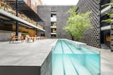 At what was formerly a run-down motel from the 1970s in Mexico City's central Cuauhtémoc neighborhood, JSa Arquitectura gave the 36-room hotel a fresh face. The interior courtyard, with a revamped, glass-edged pool, is framed by rectangular, hollow concrete bricks.