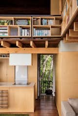 Architect and resident Andrew Simpson maximized the diminutive home with double-height ceilings, elevated compact shelving, and lofted sleeping quarters.