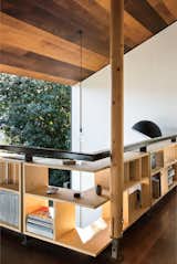 Simpson runs his practice, WireDog Architecture, from his home study, where custom bookshelves line the perimeter of the mezzanine for a storage solution that doubles as railing.