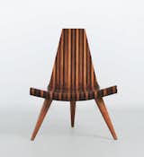 Striated shades of wood make up Brazilian designer Joaquim Tenreiro's three-legged chair from 1947.