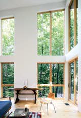 Living Room, Chair, and Light Hardwood Floor The residents splurged on double-height Marvin Integrity windows.  Photo 13 of 20 in house ideas by Kay A from A Little Cabin Cantilevered Over a Rocky Ledge in the Mountains