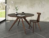 This walnut table presents a welcoming canvas for an autumnal tablescape. The Catalina Extension Table is an elegant round table that maintains the simplicity of midcentury modern design with its simple tabletop and trestle-legged structure. The table features an easy-stow retract and expand leaf within the table, making it simple to extend the table and close it to its smaller stature.