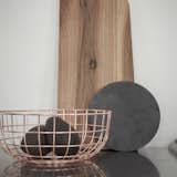 This copper-plated wire bowl can be used to hold table linens or bread on a dining room table. It can also be used for storage or as a display piece on a shelf or table. The warm copper color complements autumnal decor schemes.