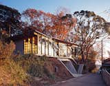 Exterior, House Building Type, Wood Siding Material, and Concrete Siding Material The architects designed the steel-frame doors and windows, which were fabricated by Takeuchi Kozai.  Photo 7 of 8 in Japanese Home Among the Trees Uses Bookshelves and Glass for Walls