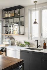 In a centuries-old building in Montreal, Belgian architect and designer Gaeten Havart undertook a DIY kitchen renovation that makes the most of inexpensive materials. These simple cabinets and modern cabinet pulls are from Ikea and painted with a matte black finish.