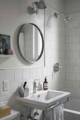 In the bathroom, there is a Catalano sink with Kohler fixtures, Artemide's Tolomeo lamp, and an Ikea mirror. To cut costs, the tiles are "the cheapest wall tiles from Home Depot," capped with a Quadec Schluter finish, Havart says.