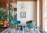 “There’s no right answer except to play and experiment,” says interior designer Jonathan Adler in regards to the Shelter Island getaway he shares with his husband, fellow design expert Simon Doonan. Custom ceramic wall tiles, a few plants, and a self-made rug, stool, and coffee table all add to the home's inimitable decor.