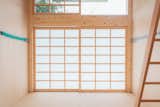 A semi-transparent, shoji-style sliding door allows filtered sunlight into the space, while also maintaining privacy.