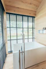 The main draw of Fukasawa's hut: a bathroom featuring a large, Japanese-style tub with a view.