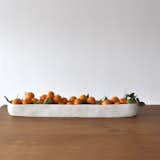 The Tina Frey Long Trough (from Tina Frey Designs) is an artful, food-safe centerpiece. Made from resin, this product's unique texture is leftover from the original mold Frey crafted in clay. At only 6 inches wide, it can slip into any accommodating table without taking up much space.