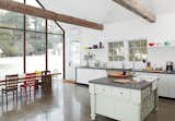 Self-taught designer Tom Givone began with a tricky task: refashioning a 19th-century structure in upstate New York into his own vacation home. In the kitchen, Givone opted to leave the structure's original beams intact while replacing the back wall with skyscraper glass.