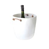 This champagne bucket by Tina Frey has a durable resin shell with knotted leather handles.  Search “resin-champagne-bucket.html” from Modern Bar Accessories
