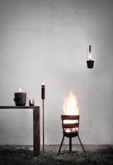 Designed by Norm Architects for Menu, the Fire Basket calls to mind the allure of a bonfire and the inviting look and feel of a fireplace. Made of oxidized steel, the basket is sturdy and resilient, and is meant to take on a rich patina over time. The series includes a Fire Torch, Wide Fire Bucket, Tall Fire Bucket, and Hurricane Lamp.  Photo 9 of 10 in A Design Duo Made in Heaven: Norm Architects and Menu
