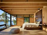Bedroom, Bed, and Wall Lighting On San Juan island, Pole Pass is an intimate waterfront retreat built to serve as a gathering space that takes advantage of the temperate Pacific Northwest summers.  Photos from Discover the Work of a Leading Seattle Modernist