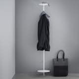 Designed with apartment-living and small spaces in mind, the Norm Coat Hanger is a sleek, powder-coated steel coat stand with a small footprint. The top platform can be used to hold a hat, keys, and sunglasses, while the lower platform can prop up a pair of shoes or a bag. Near the top of the stand, there is a hook for hanging jackets, which also extends back to the wall, giving an extra place for draping a scarf or hanging a coat from a hanger.  Search “pipework-series-coat-rack.html” from Hang It Up: 6 Modern Coat Racks and Hooks
