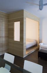 At the opposite end of the studio, Framework Architecture created a partially enclosed sleeping nook that is spacious enough to fit a full-size bed.