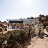 Situated on a sloping desert plot just north of Joshua Tree National Park, the Blue Sky house hovers above its surroundings thanks to the support of six steel columns.  Photo 1 of 6 in Modern Homes with Steel Exteriors by William Harrison