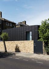 Located on an infill lot, the house is clad with Anthra Zinc panels by VMZinc.  Search “panel house” from Small But Mighty Passive House in London