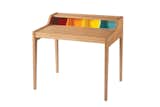 From the Remix line, an extendable oak desk based on the classic Davenport silhouette is updated with the addition of four colorful compartments.
