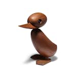 Inspired by the 1959 newspaper photos of a mother duck crossing the street with her ducklings, this wood duck is handcrafted from teak and features smooth, rounded forms and an elongated beak. A playful celebration of a heartwarming story, the duck can be used as a standalone accent or grouped with a duckling or two.  Search “duck bag chestnut” from Icons of Danish Design: Wooden Ducklings and Birds