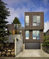 “BLK_LAB uses a series of thoughtfully placed windows to achieve a combination of passive solar design and an advanced thermal envelope,” says architect Christopher Patano, founder of Seattle firm Patano Studio Architecture. The home is insulated with cellulose, a material made from 85 percent post-consumer recycled content, which is densely packed into each stud cavity.  Photo 3 of 5 in Modern Houses That Embrace the Seattle Landscape by Allie Weiss from A Light-Filled Renovation Helps a 1950s Seattle Home Go Green