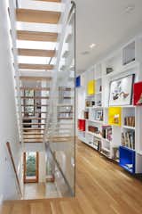 “The interior was designed as a backdrop to the art and life of its inhabitants,” Clarkson noted. “A custom-built wall of display cubes adds an accent of primary color in the second floor hallway.” Solid white oak flooring continues onto the second level from the stairs, and Middlebrook Woodworking Ltd. lacquered that same material for the display cubes.