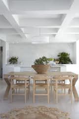 The dining room features a dining table by Australian brand Zuster and Hans Wegner chairs.