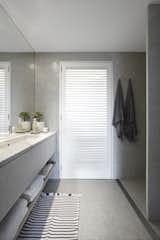 Carrara marble was used in the vanity and the bathroom partitions while shutters let in additional light from the outside.