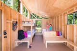 Bedroom, Bunks, Bed, and Chair Designed by Cal Poly Pomona students, this factory-built Wedge cabin prototype features plywood interiors for a raw and rustic vibe.   Photo 2 of 5 in Modern Prefab Cabins for California State Parks