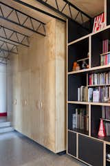 The open-plan area is lined with custom plywood cabinets.