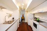The galley kitchen, which includes a washer/dryer combo, separates the living room and bedroom.