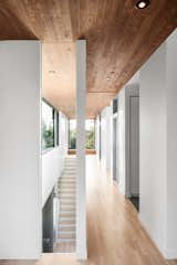 A ceiling of stained cedar lines the hallway of the second level. The home features three bedrooms on the second floor, and a ground-level playroom that can be converted to a private sleeping area when guests arrive.  Search “naturehumaine” from Favorites
