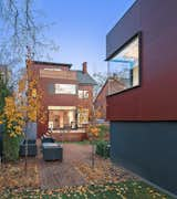 The Parklex facade visually connects the main house and coach house. “We wanted to use an exterior material that harmonized with the house’s context, which is an older neighborhood filled with Victorian houses made of Toronto red clay brick,” architect Heather Dubbeldam says.  Search “contemporary nordic town house” from A Cramped Boarding House Transformed Into an Open, Modern Home in Toronto