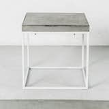 The Oakland table is topped by a raw-concrete slab.