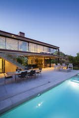 “The decision to open up the back of the home played multiple roles: it provided a link between the upper and lower levels, engaged us with the park, ocean and valley just beyond, and at night turned the home into a lantern – marking the entrance to this hillside community.” Schultz says. Outdoor furniture from Gloster and Les Jardins make for ample poolside seating.