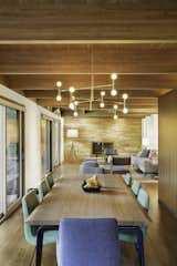 “The new floor plan is considerably more open than the original plan, and the interior and exterior details have been simplified and made consistent,” Schultz said. A Lambert & Fils light fixture illuminates a dining set by Ligne Roset.