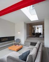 The extension steps down from the dining room, and the ceiling follows suit. The skylight and window wall focus daylight through the back of the original house.  Photo 4 of 8 in A London Town House Renovation Beaming with Personality