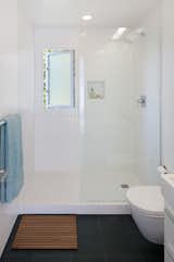 The master bathroom is clad in inexpensive tile from Daltile. The wall-hung toilet is by Duravit.