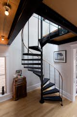 Shively had a carpenter from TomKal Construction build a custom handrail, out of white oak to match his floors, for this spiral staircase.
